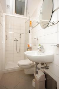 a bathroom with a sink and a toilet and a mirror at Apartments with a parking space Opatija - 3436 in Opatija