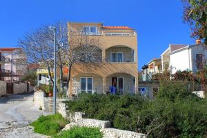 a house on a street with a street light in front at Apartments by the sea Businci, Ciovo - 4668 in Trogir