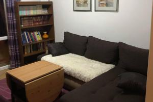 a living room with a couch and a book shelf at Apartments by the sea Businci, Ciovo - 4668 in Trogir