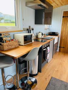 a kitchen with a counter with a microwave on it at Red darren luxury hut in Llanveynoe