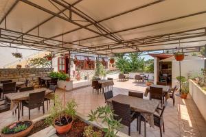 an outdoor patio with tables and chairs and a patio at Double Room Mali Losinj 3445h in Mali Lošinj