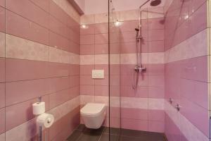 a pink bathroom with a toilet and a shower at Double Room Mali Losinj 3445h in Mali Lošinj