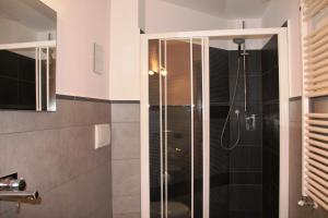 a bathroom with a shower with a glass door at B&B Magnifico Messere in Florence