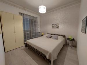 a bedroom with a bed and a glass shower at Apartments by the sea Duga Luka - Prtlog, Labin - 3025 in Labin