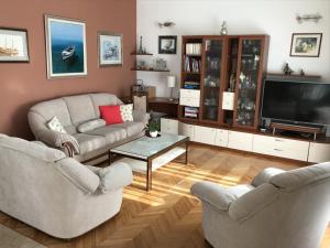 a living room with two couches and a flat screen tv at Apartments with a parking space Duce, Omis - 2778 in Duće