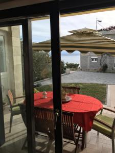 a table with a red table cloth on a patio at Apartments with a parking space Duce, Omis - 2778 in Duće