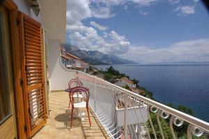 - Balcón con silla y vistas al agua en Apartments by the sea Pisak, Omis - 2750, en Pisak
