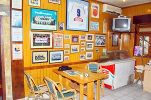 a restaurant with a table and a tv on a wall at Studio Omis 2757a in Omiš