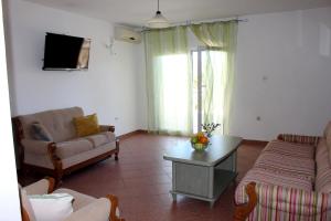 a living room with a couch and a table at Apartments by the sea Mimice, Omis - 2774 in Mimice
