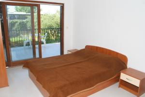 a bedroom with a large bed and a balcony at Studio Duce 2746b in Duće