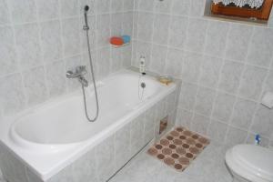 a bathroom with a shower and a tub and a toilet at Apartments and rooms by the sea Duce, Omis - 2746 in Duće