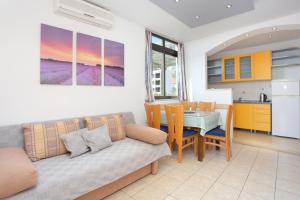 a living room with a couch and a table at Apartments by the sea Tucepi, Makarska - 2721 in Tučepi