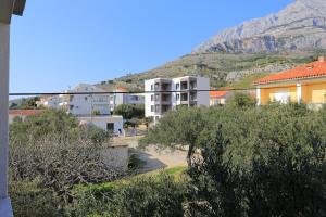 a view of buildings with a mountain in the background at Apartments by the sea Tucepi, Makarska - 2721 in Tučepi