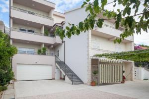 an image of a house with a garage at Apartments by the sea Tucepi, Makarska - 2677 in Tučepi