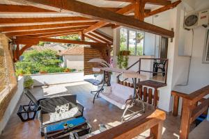 a patio with a table and chairs on a porch at Apartments by the sea Sumpetar, Omis - 2808 in Sumpetar