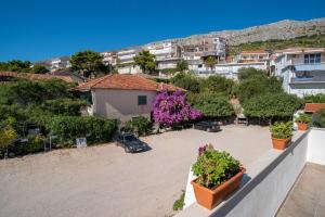 a view from the balcony of a apartment with plants at Apartments by the sea Sumpetar, Omis - 2808 in Sumpetar