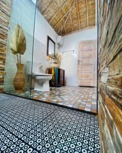 a bathroom with a sink and a toilet in a room at Gara Gara Sea View in Nusa Penida