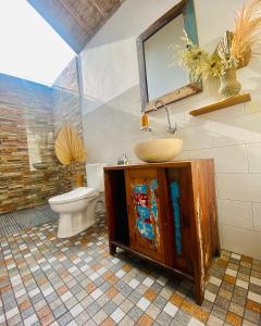 a bathroom with a sink and a toilet at Gara Gara Sea View in Nusa Penida