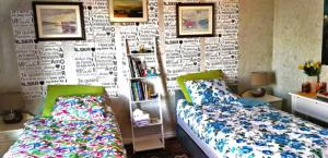 a bedroom with a bed and a book shelf at Nahlboms in Sandefjord