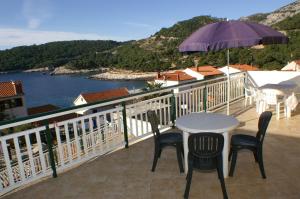 a table and chairs on a balcony with a view of the water at Studio Milna 3074c in Hvar