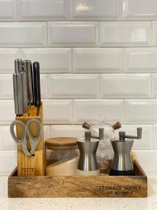 a wooden tray with kitchen utensils on a counter at The Browns Casita in Panabo +3 photos