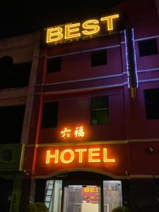 a neon hotel sign on the side of a building at Best Hotel in Skudai
