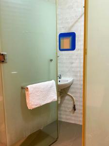 a bathroom with a sink and a shower with a towel at Best Hotel in Skudai