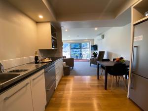 a kitchen with a table and a dining room at Two Bedroom Apartment on the water in Picton