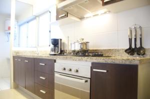 a kitchen with a stove and a counter top at Apartments in Miraflores in Lima
