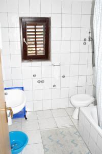 een witte badkamer met een toilet en een wastafel bij Apartment Mandre 3084c in Kolan