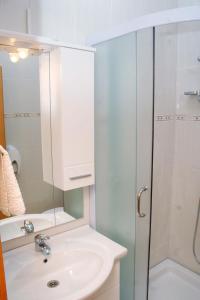 a bathroom with a sink and a shower at Double Room Rogoznica 3097a in Rogoznica