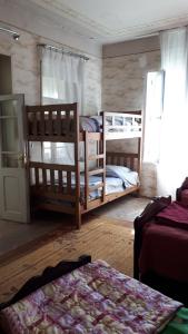 a bedroom with two bunk beds and a window at Guesthouse Angelina-Koko in Sighnaghi