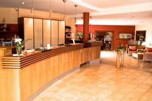 a large lobby with a counter and a lobby at laVital Sport- & Wellness Hotel in Wesendorf