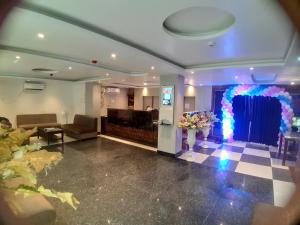 a lobby with a large room with a flower arrangement at Hotel Crown Palace in Patna
