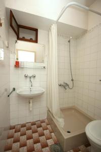 a bathroom with a sink and a tub and a toilet at Apartments by the sea Bol, Brac - 4657 in Bol
