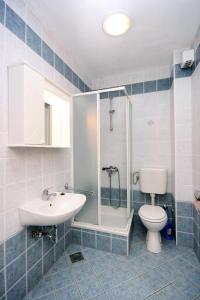a bathroom with a sink and a toilet and a shower at Apartments with a parking space Duce, Omis - 4650 in Duće