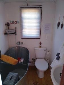 a bathroom with a tub and a toilet and a sink at Jamais le même in Kakamas