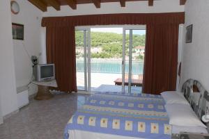 a bedroom with two beds and a view of a pool at Apartments by the sea Cove Jagodna - Brusje, Hvar - 4619 in Brusje