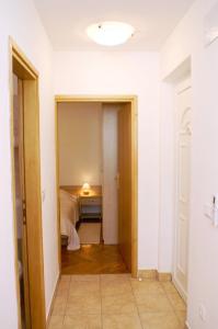 a hallway with a bed and a table in a room at Apartments by the sea Vinjerac, Zadar - 3093 in Vinjerac +59 photos