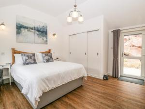 a bedroom with a bed and a window at The Old Mill Bake House in Ross on Wye