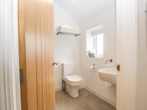 a white bathroom with a toilet and a sink at The Old Mill Bake House in Ross on Wye +15 photos