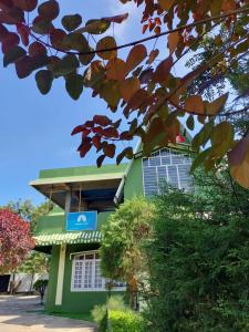 een groen gebouw met een bord ervoor bij Odyssey Stays Jowai - West Jaintia Hills in Jowai