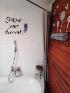 a bathroom with a sink and a sign that reads follow your dreams at Mai lo stesso in Kakamas