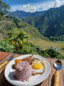 a plate of breakfast food on a table at Batad Countryside in Banaue