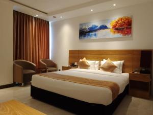 Postel nebo postele na pokoji v ubytování Hotel X Rajshahi + 19 fotografií