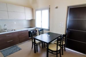 a kitchen with a table and chairs in a kitchen at VergaView Luxury House in Kalamata