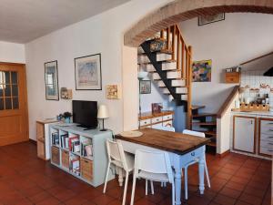 a kitchen and dining room with a table and a staircase at Cà Rossa in Imola