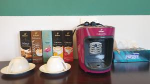 a toaster sitting on top of a table next to dishes at Texas House in Novaci-Străini