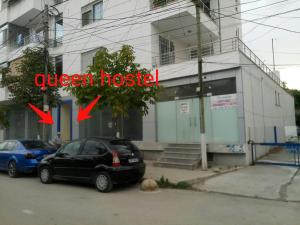 a black car parked in front of a building at Queen Hostel in Durrës