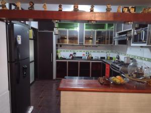 a kitchen with a counter top and a refrigerator at Inka Ayllu Hospedaje in Lima